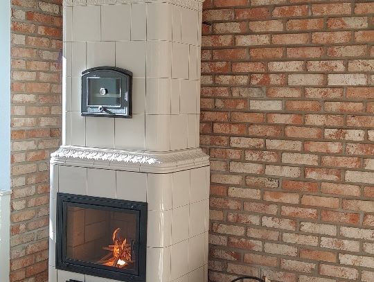 Piec kaflowy Biały piec kaflowy na ceglanej ścianie